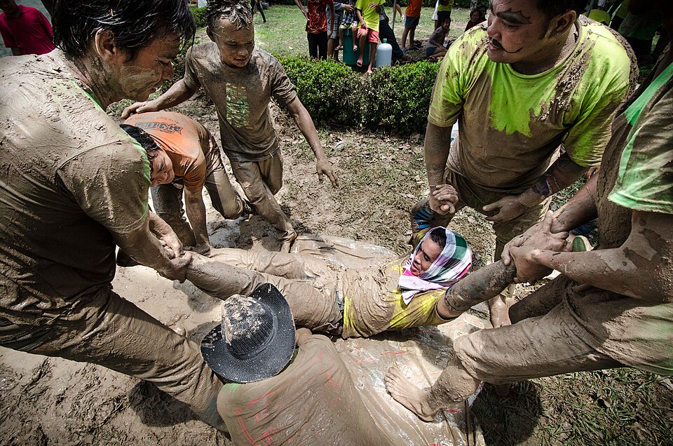 Festival-goers covered in mud at the Bun Bang Fai rocket festival in Thailand