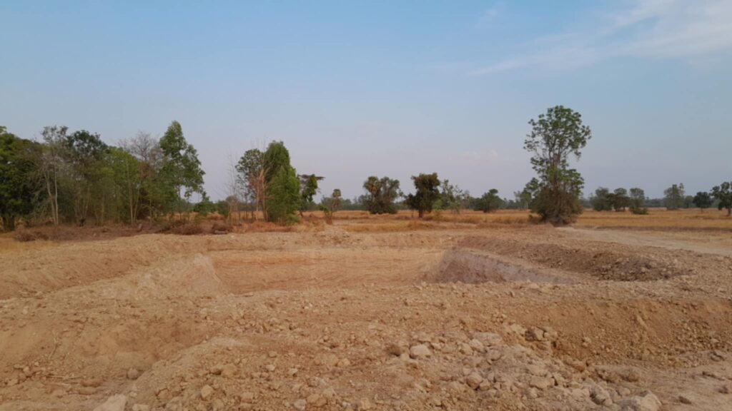 Excavated fishing pond on rural land in Krasang district, Buriram province, northeast Thailand