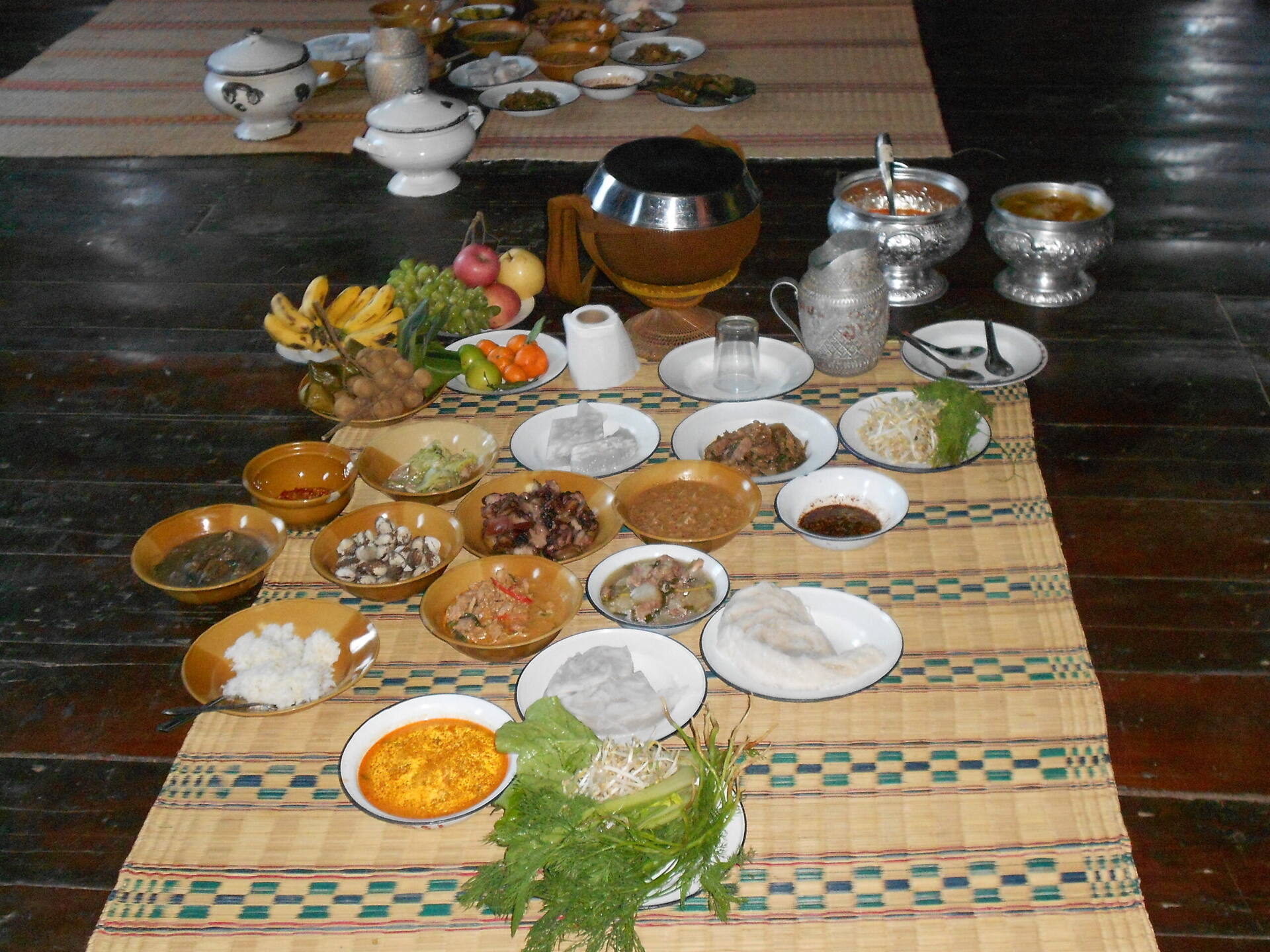 Food offerings prepared for monks at Buddhist temple in Buriram, Thailand