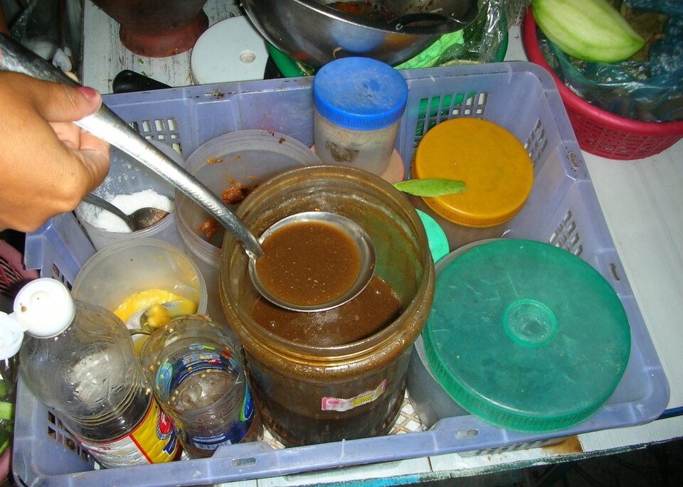 A clay pot of pla ra on a street food vendor's cart in Thailand