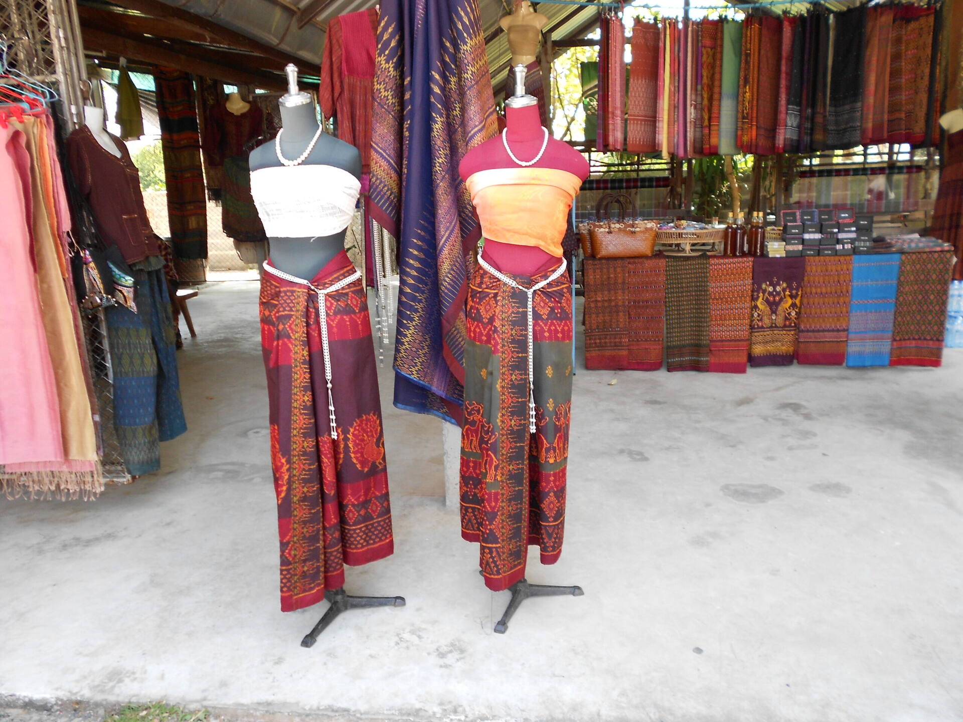 Mannequins wearing traditional Isaan silk wrap-skirt outfits at Ban Tha Sawang silk village, Surin province