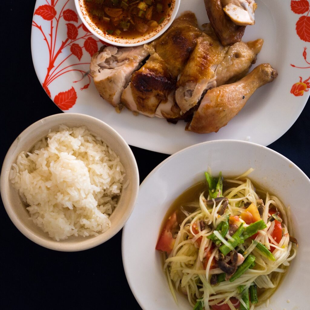 Som tam, sticky rice and gai yang grilled chicken, the classic Isaan meal